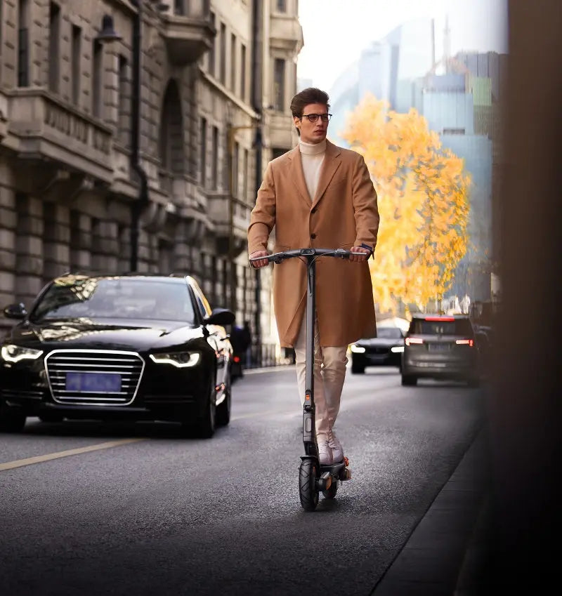 Load image into Gallery viewer, Fashion model riding Yadea ElitePrime e-scooter in an urban setting