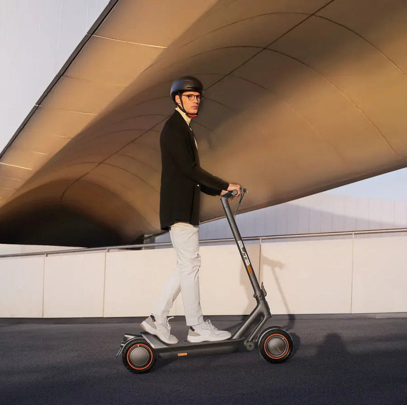 Load image into Gallery viewer, Model riding an ElitePrime electric scooter on the road