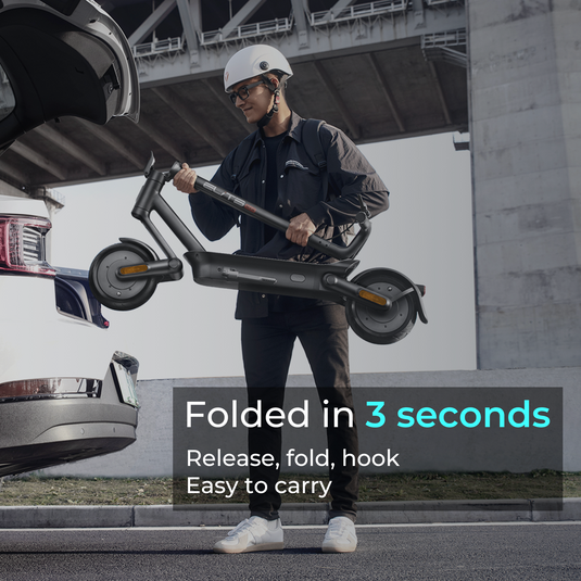 a male model is putting a folded escooter into the trunk of a car